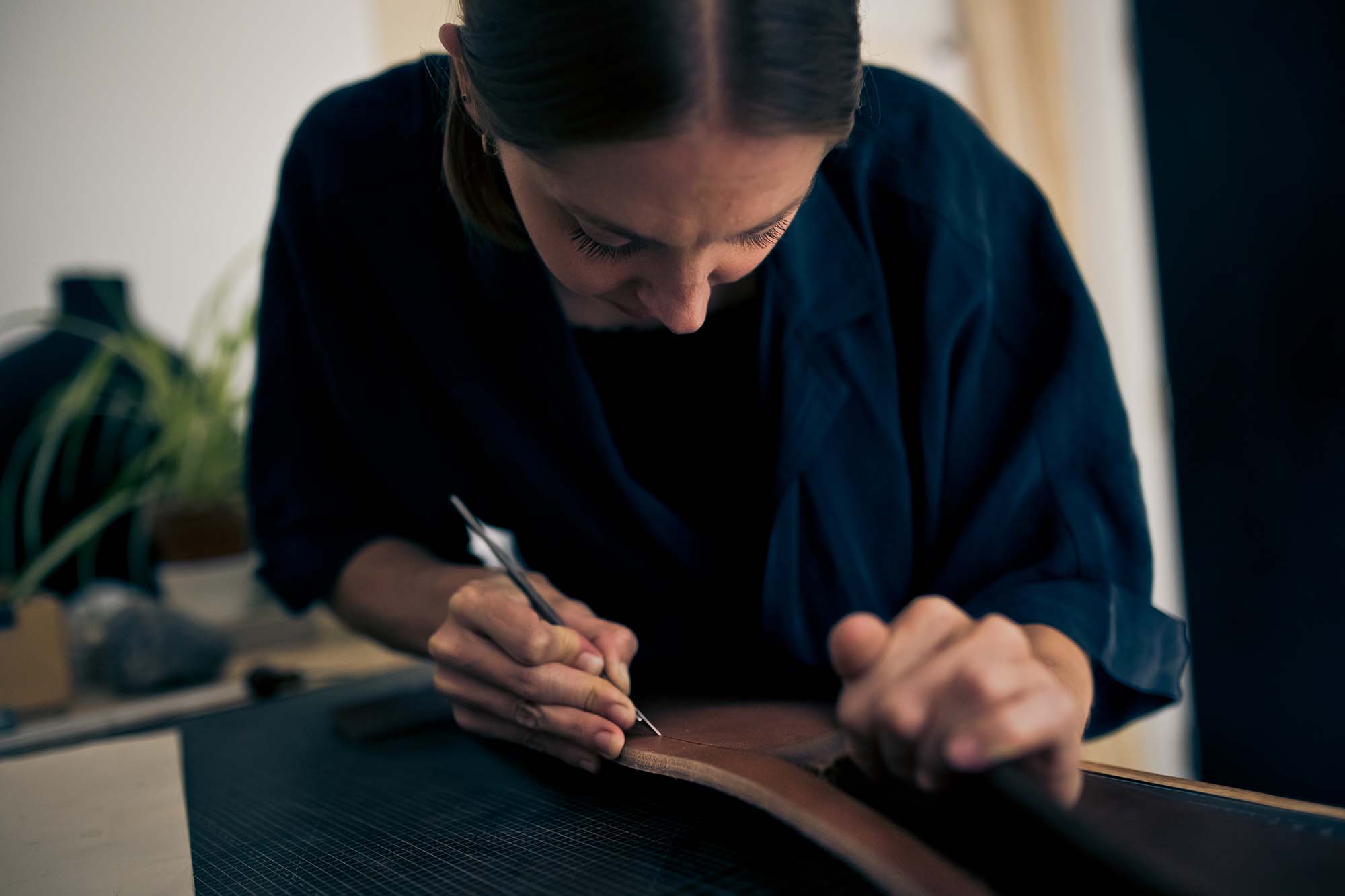 woman working on a piece of leather