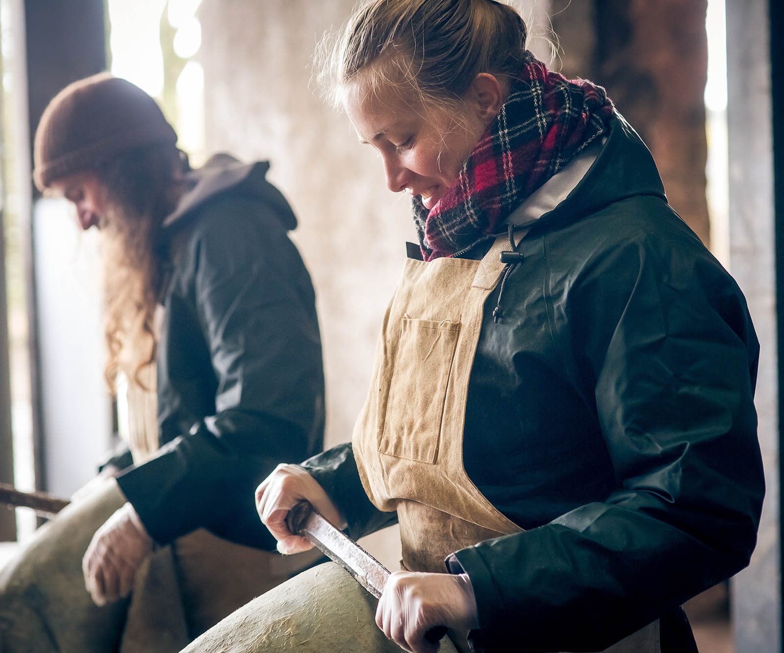 a man and woman fleshing leather