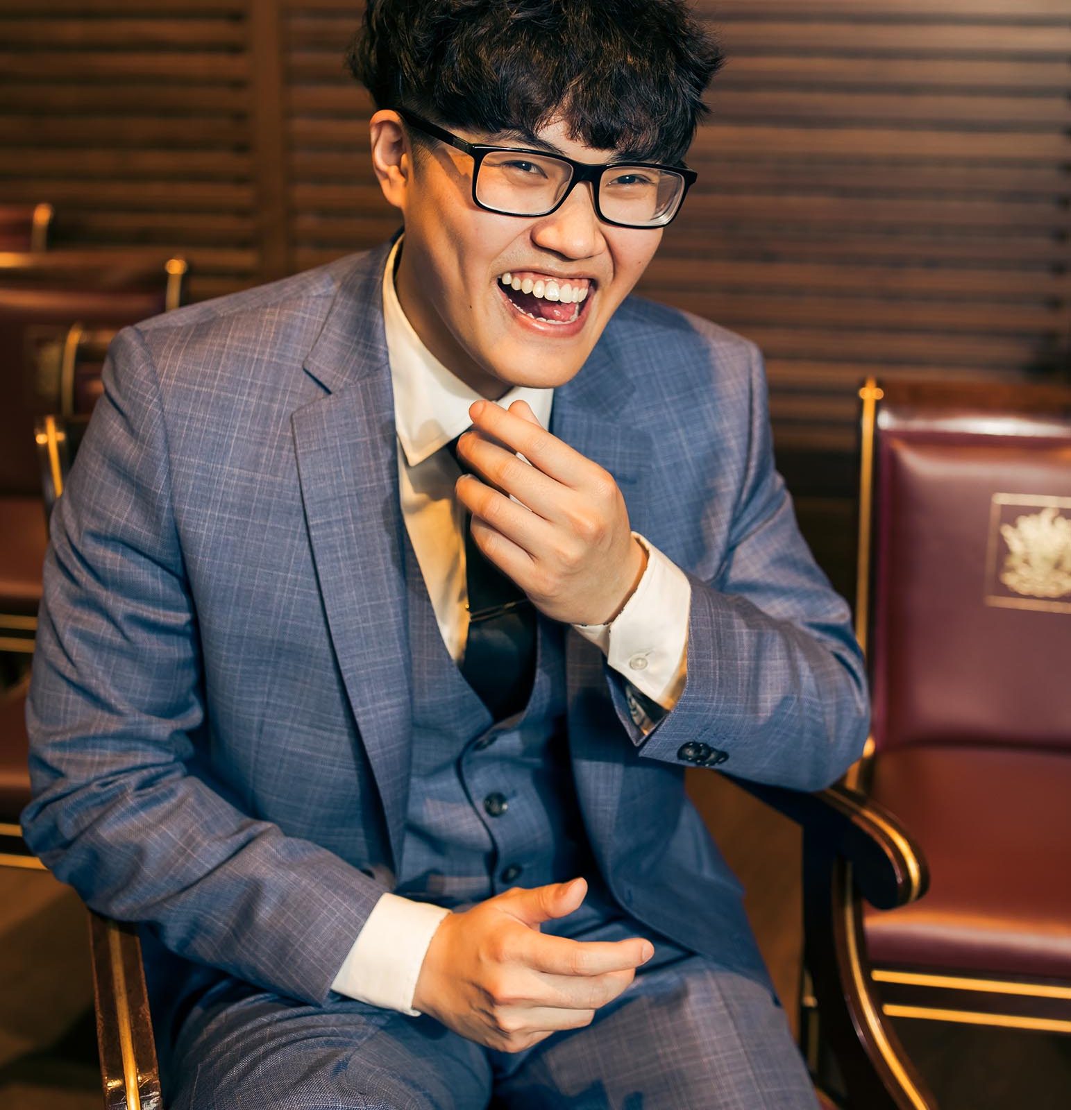 man in blue suit laughing