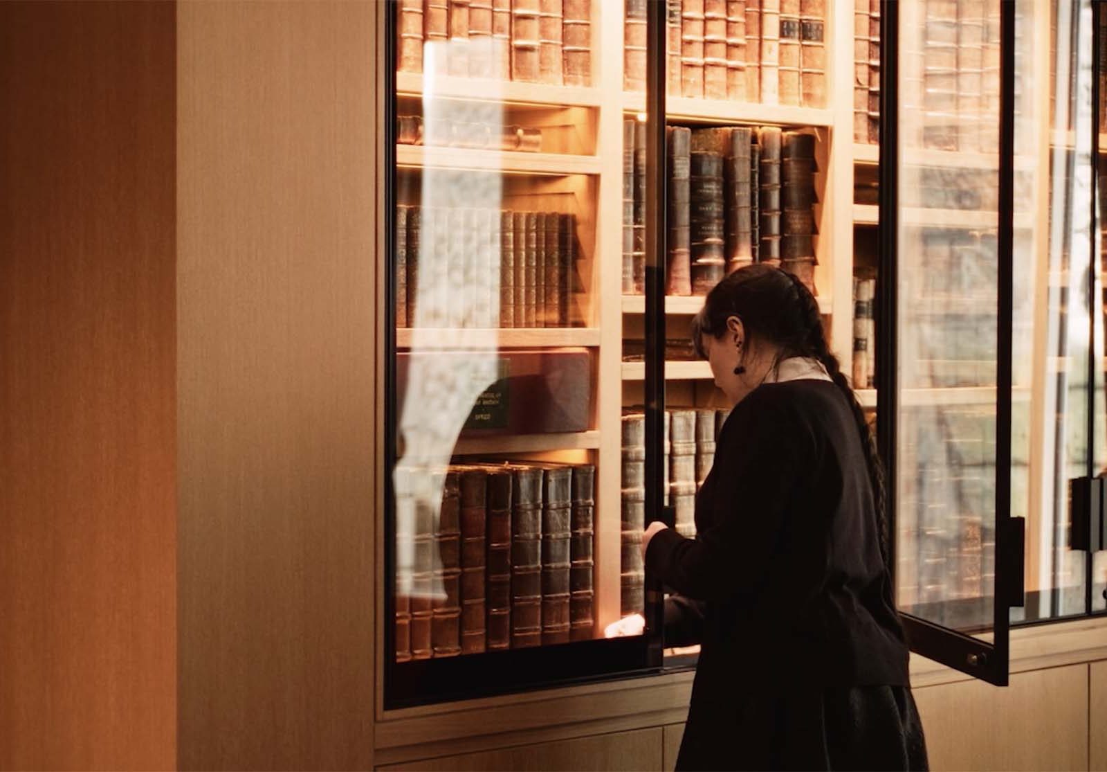 woman taking books from a library