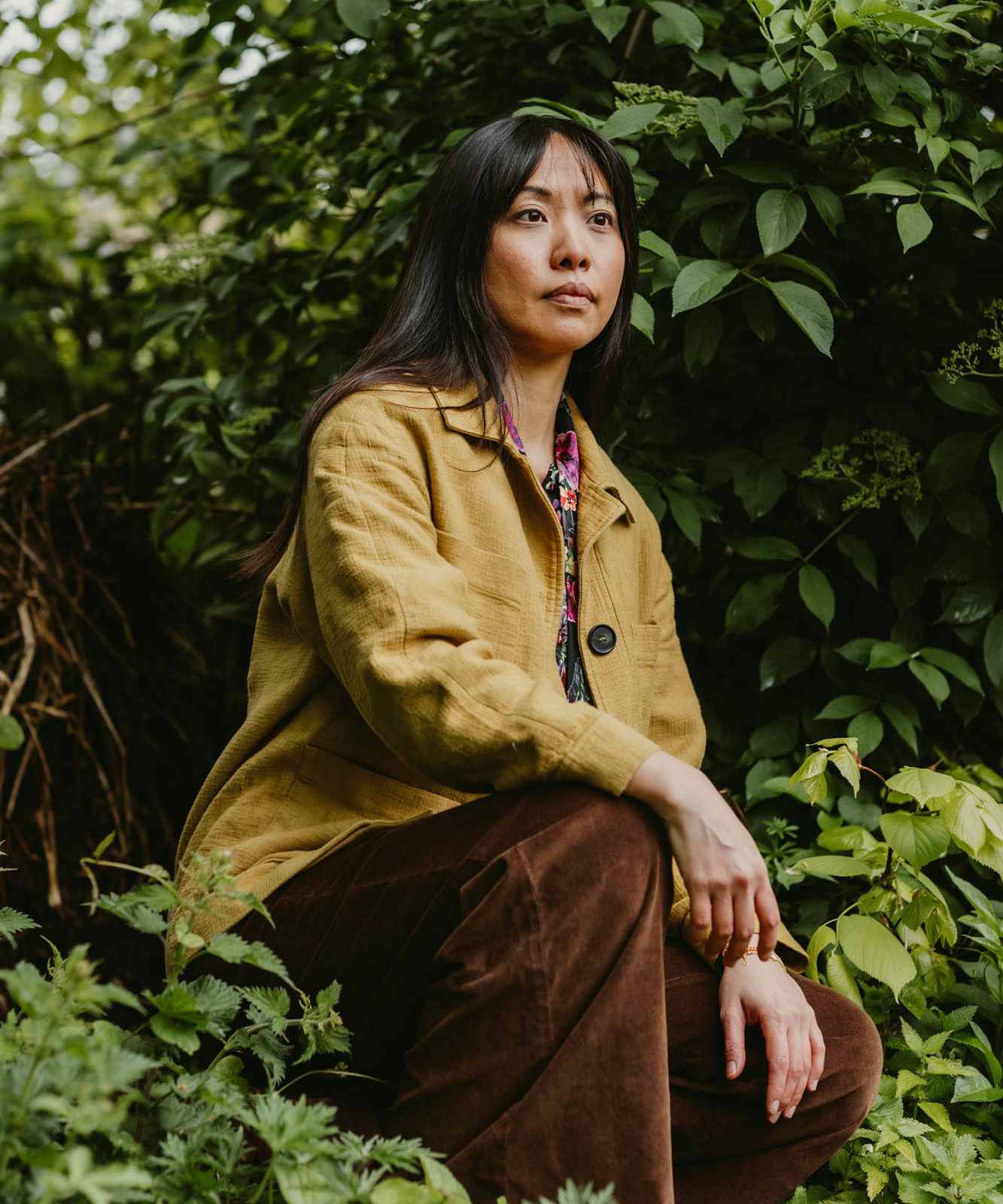 woman kneeling amongst plants