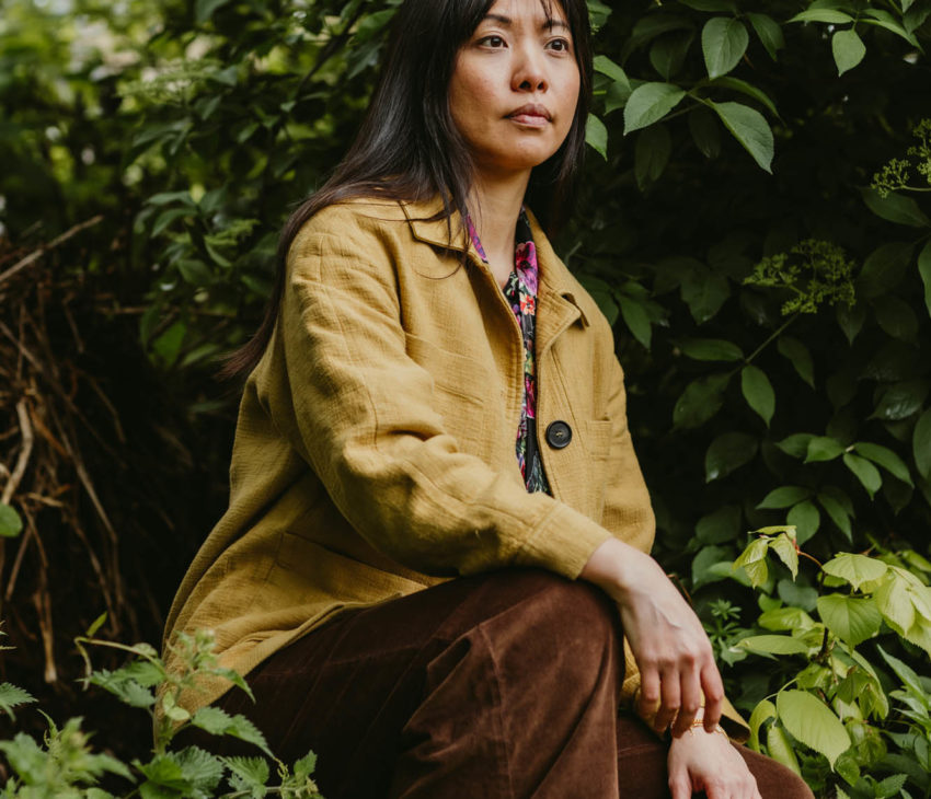 woman kneeling amongst plants