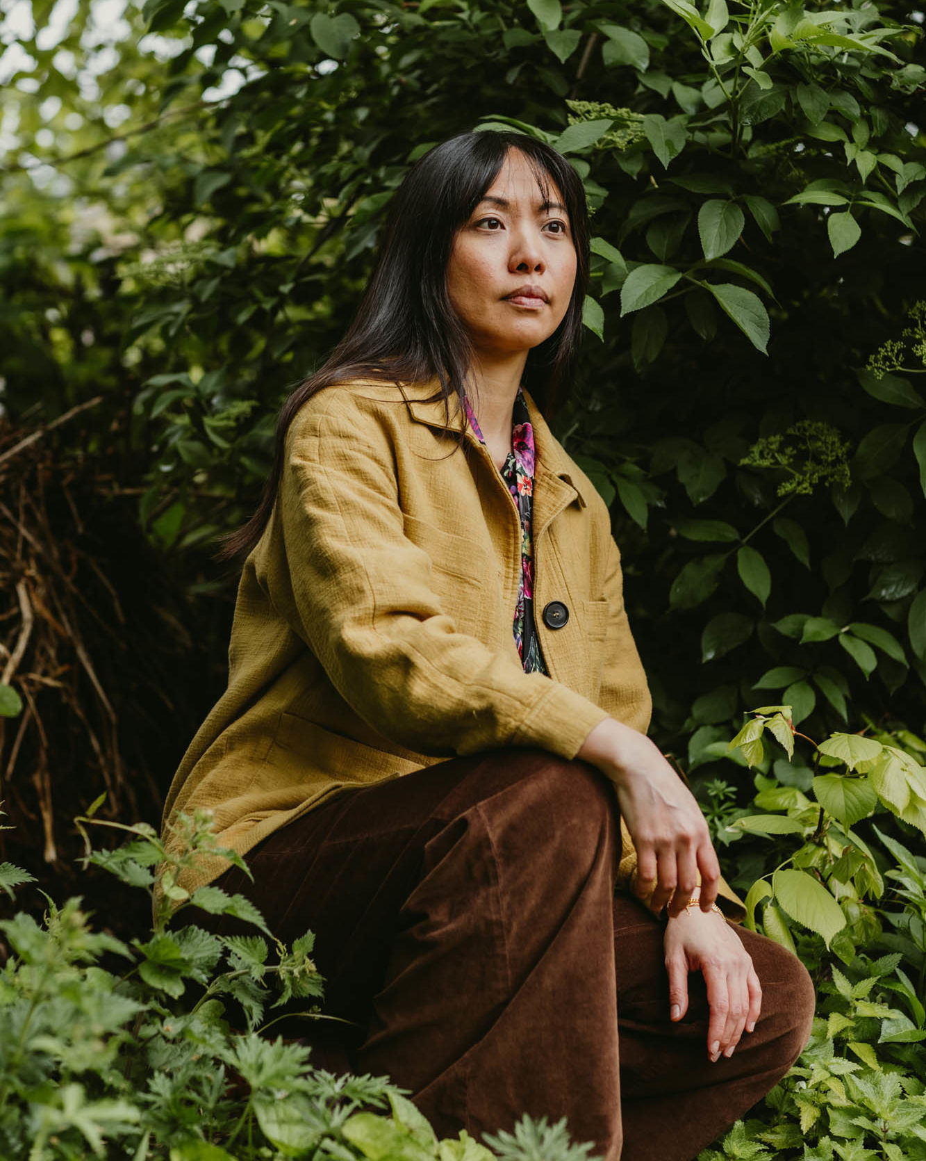 woman kneeling amongst plants