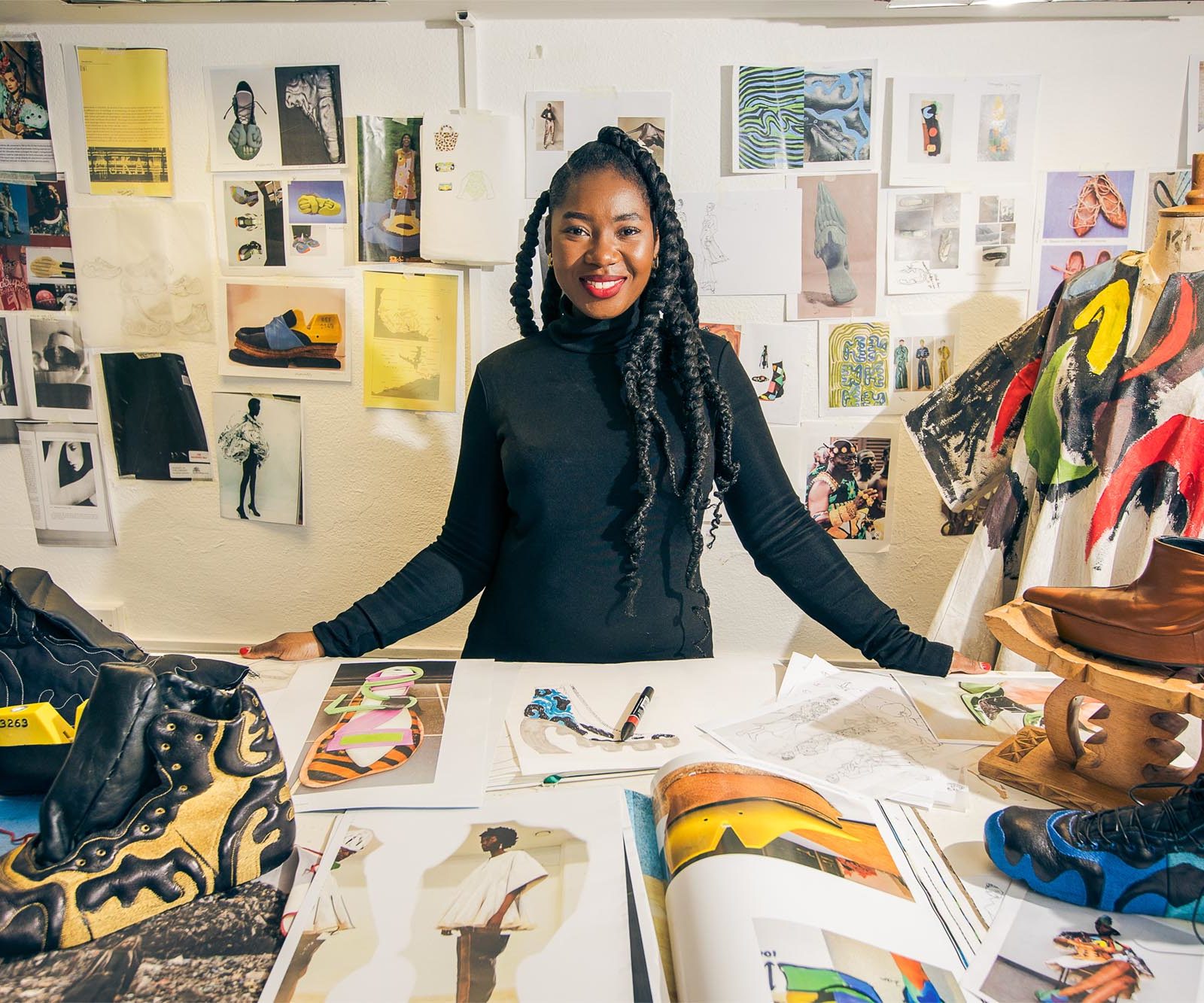 woman in a studio with leather shoes and designs