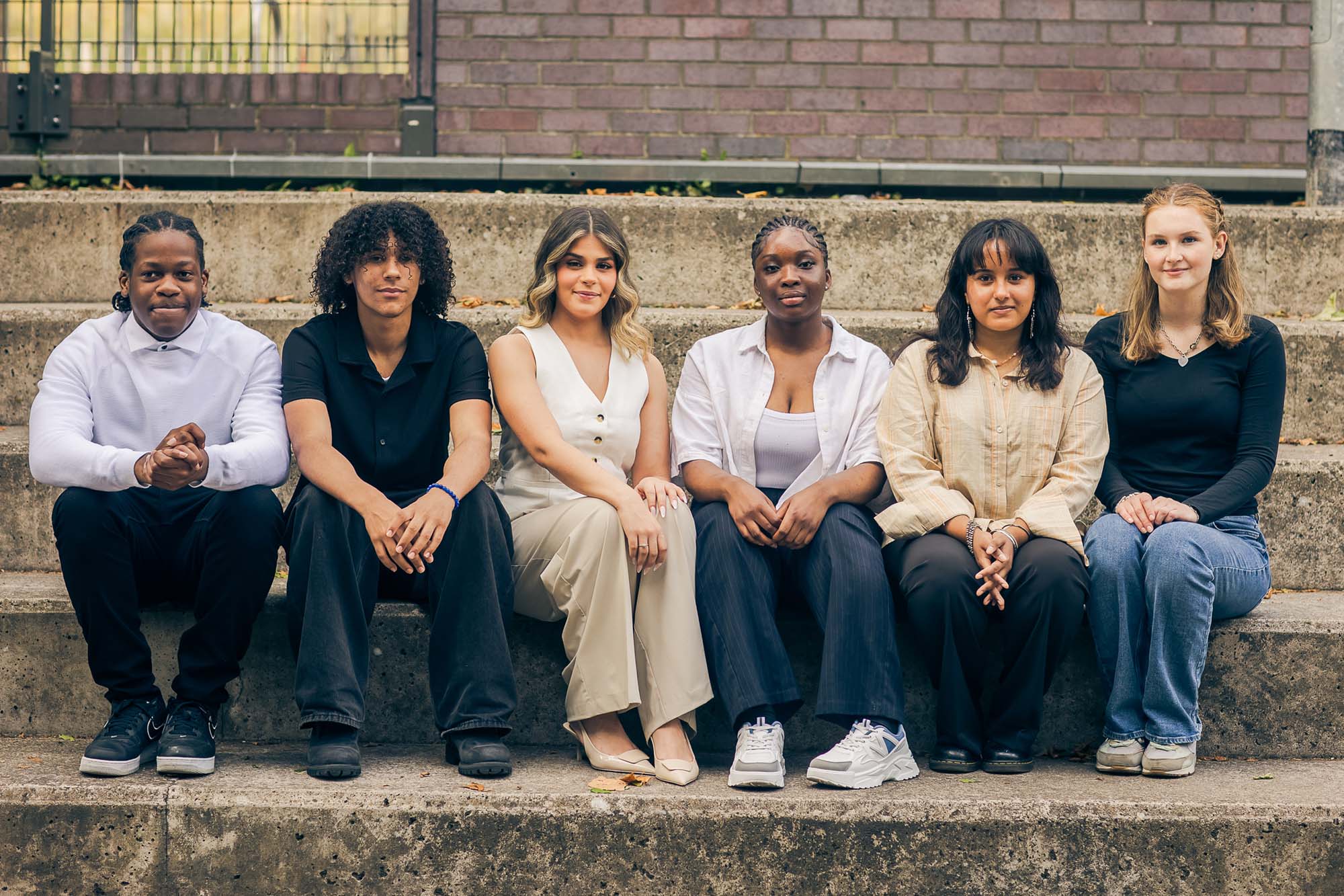 young people sitting on a wall