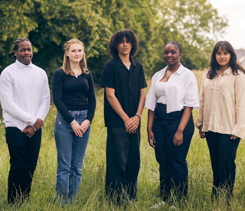 young people standing in a field