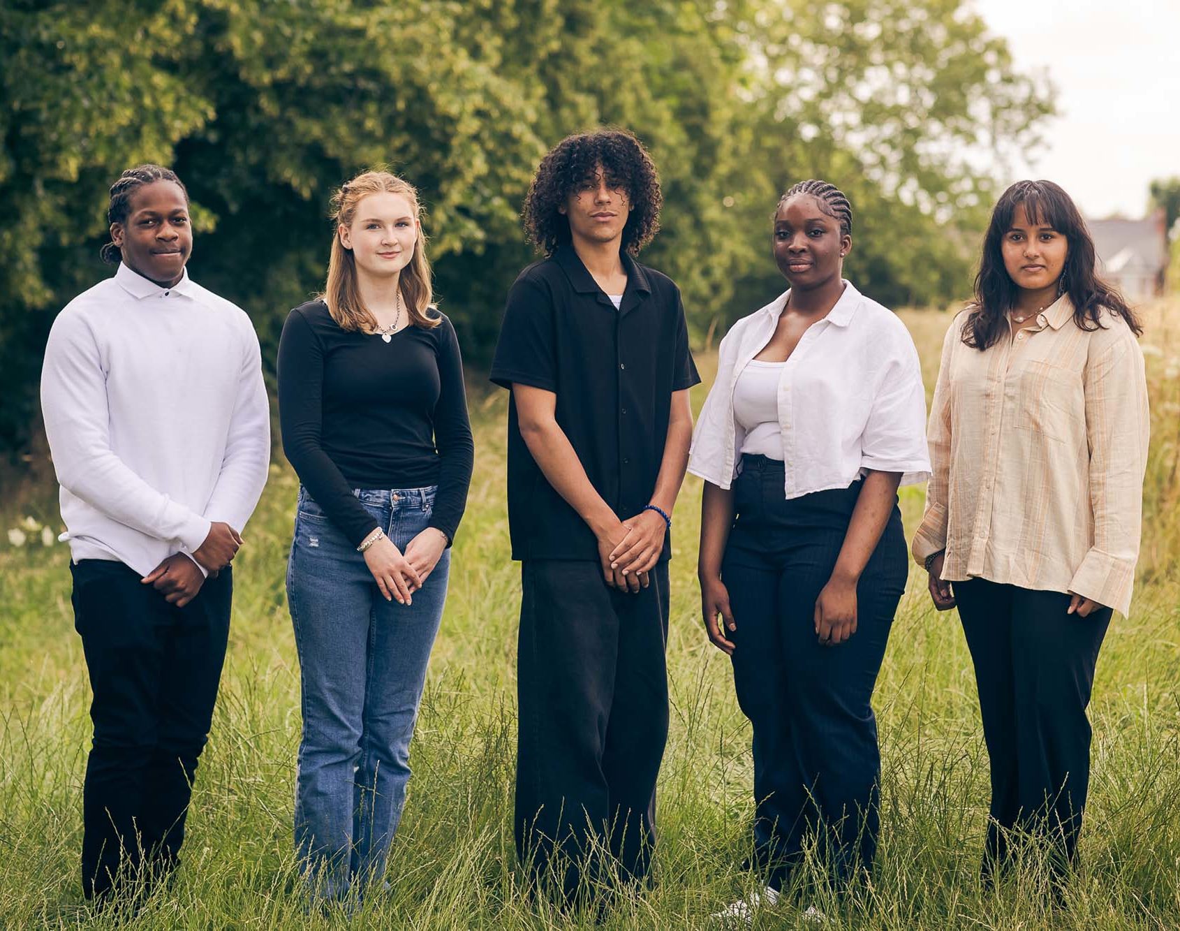 young people standing in a field