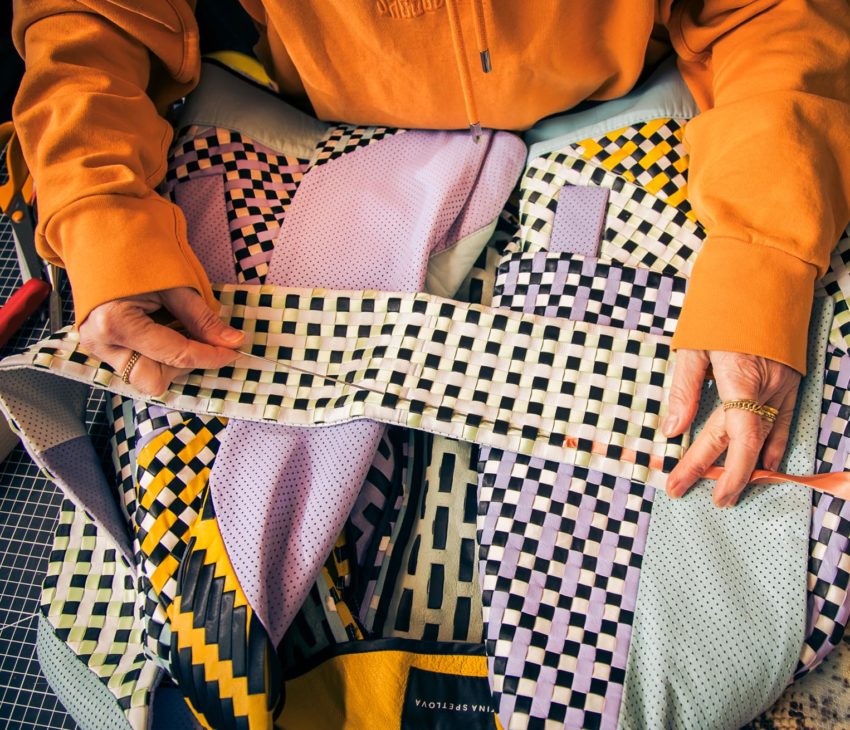 woman weaving leather and fabric strips