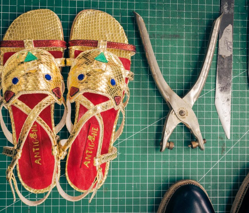 a pair of sandals and shoemaking tools