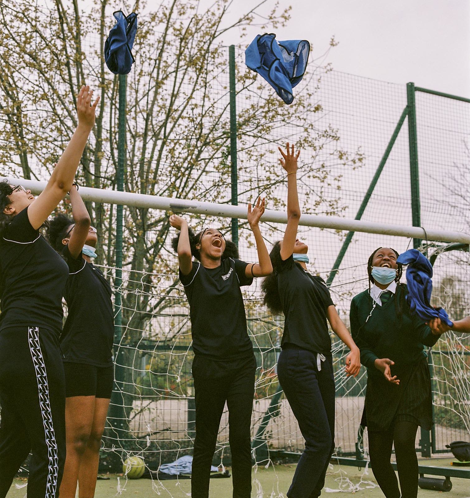 Children throwing t-shirts in the air